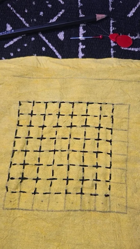 Cross stitch pattern on yellow fabric