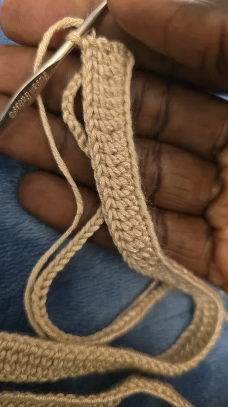 Hand holding crocheted strip